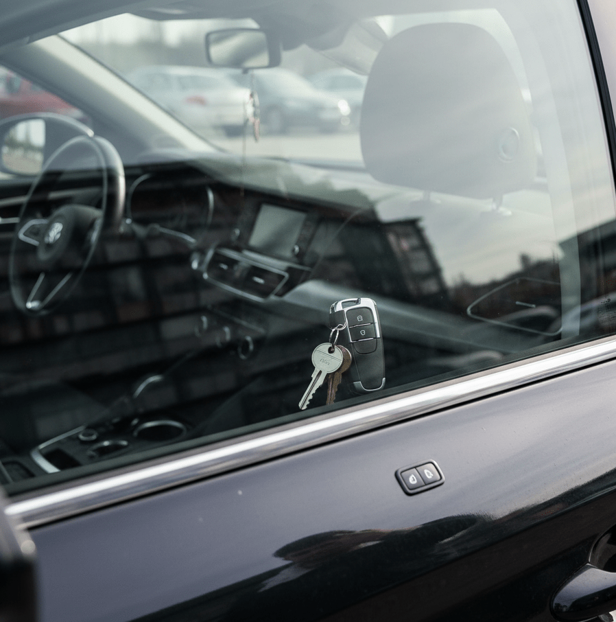 Car interior showing keys in the ignition, highlighting locksmith services for lock repair and key cutting in Charlotte.