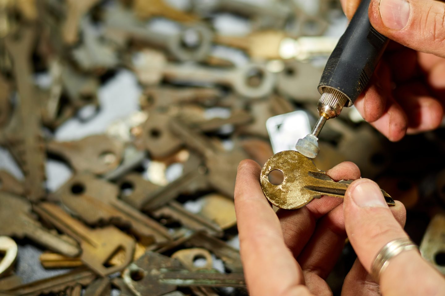 Locksmith cutting and duplicating a new key in workshop for Charlotte customers
